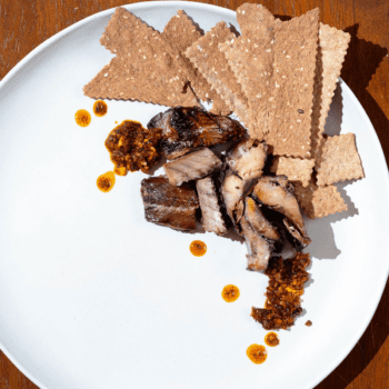 Image of a serving suggestion (chili oil and crackers) for Wildfish Cannery Smoked Herring
