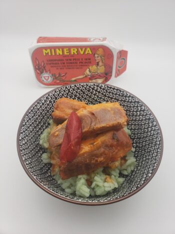 Image of Minerva sardines in hot tomato sauce plated on bamboo rice with pepper