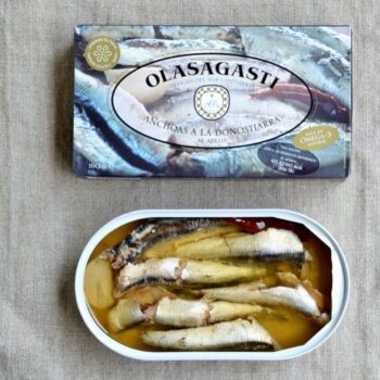 Image of the box and an open tin of Olasagasti Whole Anchovies in the Basque Style