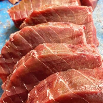 Image of Güeyu Mar Chargrilled Tuna Neck (Morillo de Atún) cuts before grilling and canning.