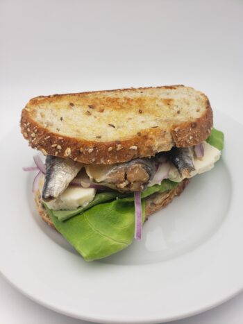 Image of La Brujula sardines 3/4 #34 on sourdough with gorgonzola and red onion