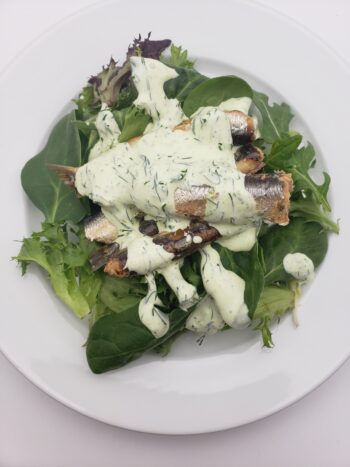 Image of les mouettes d'arvour anchovies in olive oil on salad with green goddess dressing