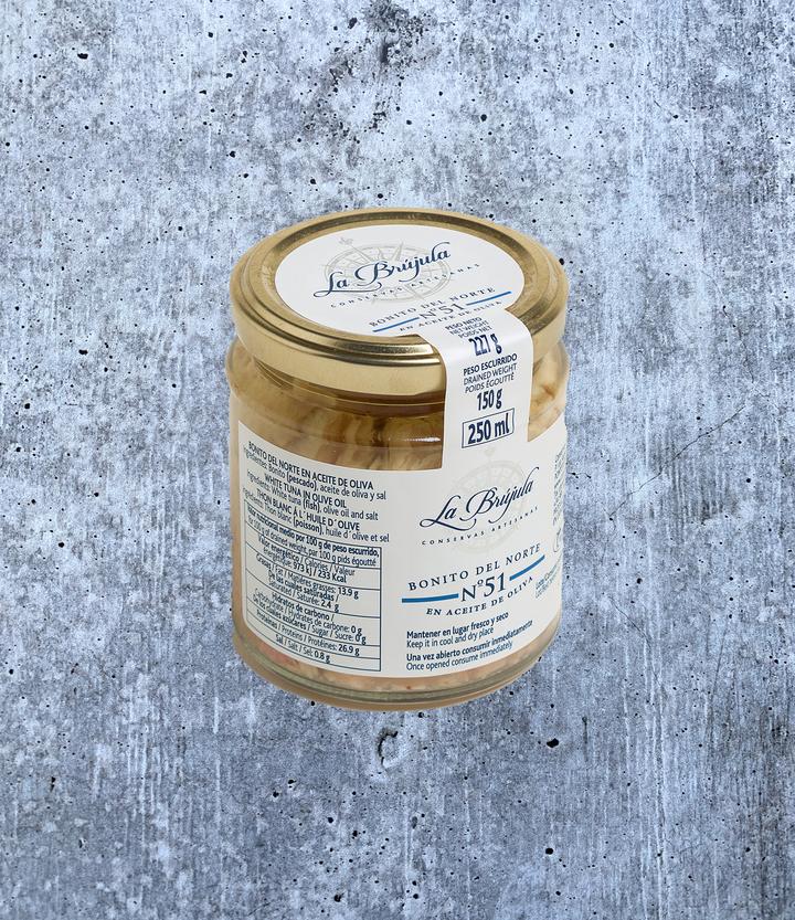 Image of the front of a jar of La Brújula White Tuna (Bonito del Norte) in Olive Oil, glass jar