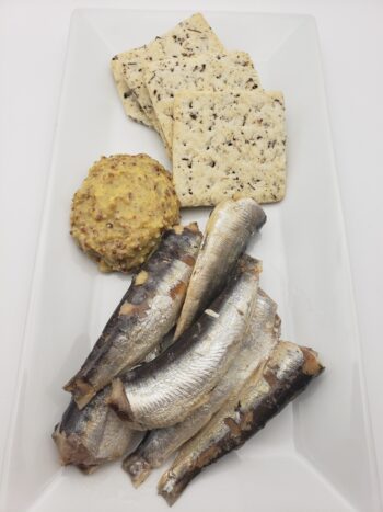 Image of Yurrita sardinillas plated with basil crackers and whole grain mustard