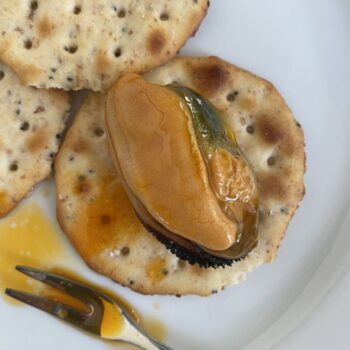 Image of a Yurrita Mussels in Pickled Sauce (Mejillones en Escabeche) 8/12 on a cracker