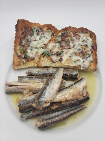 Image of Patagonia roasted garlic anchovies on plate with buttered toast