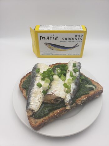 Image of Matiz sardines with lemon plated with wheat toast, pesto, and chives