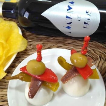 Image of a tapa/pintxo made with olives and pequillo peppers and guandilla peppers