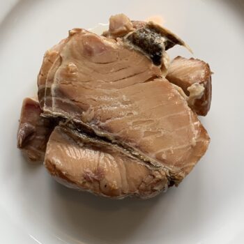 Image of the contents of an inverted tin of Wildfish Cannery Smoked White King Salmon