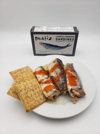 Image of Matiz lightly smoked sardines on plate with mule sauce and crackers