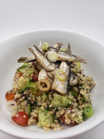 Image of King Oscar royal sardines with manzanilla olives on tabbouleh salad