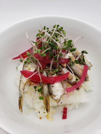 Image of King Oscar sprats in olive oil on rice with pickeld onion