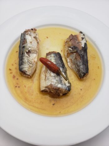 Image of Porthos sardines in hot vegetable oil on plate