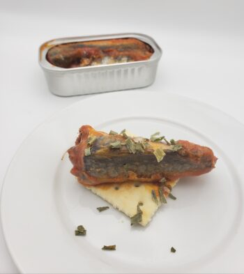 Image of Flower Moroccan Sardines in Tomato Sauce plated on a saltine with chives