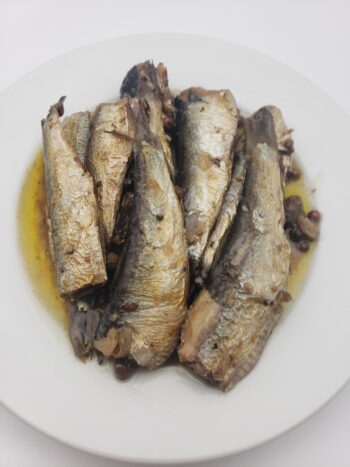 Image of King Oscar sprats with olive oil and spiced cracked pepper on plate