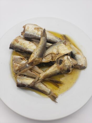 Image of King Oscar sprats with olive oil and jalapeno on plate