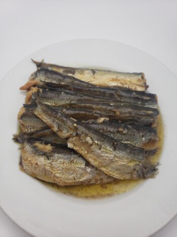 Image of King Oscar sprats with olive oil and lemon on plate