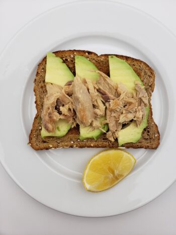 Image of King Oscar mackerel in olive oil on toast with avocado and lemon