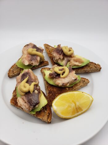 Imagof King Oscar skinless and boneless sardines on toast with avocado and mustard