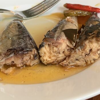 Image of a forked open fish from a tin of Nuri Spiced Mackerel in Olive Oil