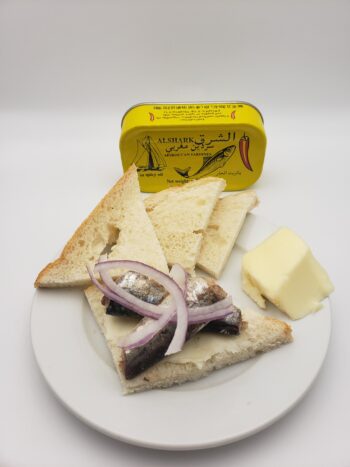 Image of Alshark spicy sardines on buttered bread with onion