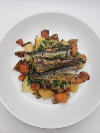Image of Groix & Nature sardines in lobser oil plated with potatoes, greens, and roasted carrots