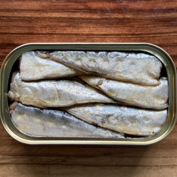 Image of an open tin of Ramón Peña Small Sardines in Spicy Olive Oil 12/16, Silver Line