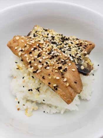 Image of mouettes d'arvor sardine fillets in olive oil plated on rice with furikake