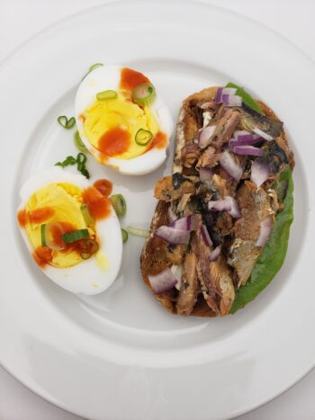 Image of Mouette d'arvor sardines with piment d'espelette plated on toast with egg
