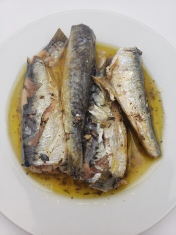 Image of les mouettes d'arvour sardines with thyme and basil on plate