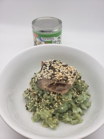 Image of Nissui mackerel in olive oil plated with bamboo rice and furikake