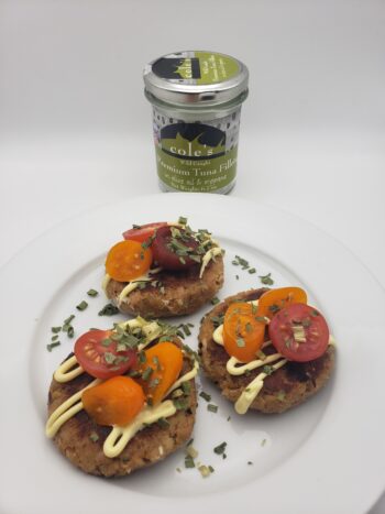 Image of Coles tuna fillets in olive oil with oregano plated as patties with mayo and tomatoes