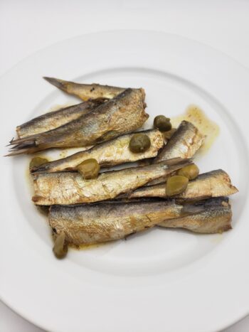 Image of king oscar sardines with vinegar and capers on plate