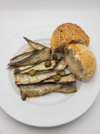 Image of king oscar sardines with vinegar and capers plated with fresh bread