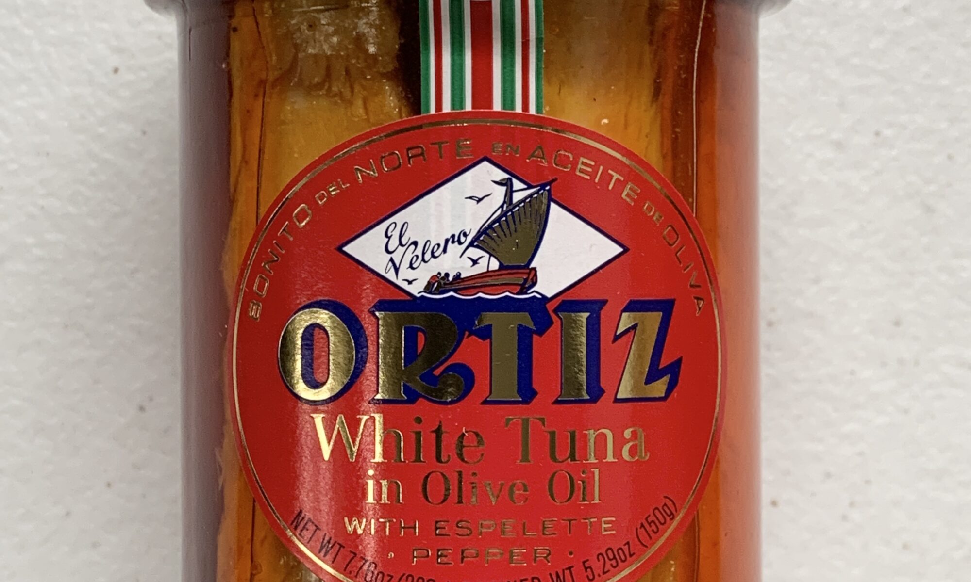 Image of the front of a jar of Ortiz White Tuna in Olive Oil with Espelette Pepper, glass jar