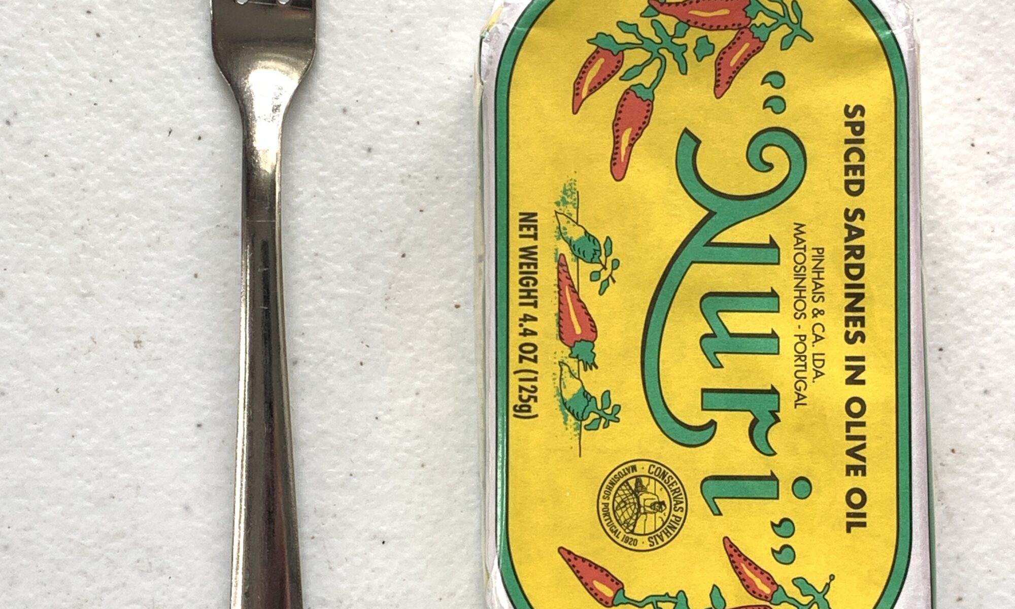 Image of a Cocktail Fork, Choice Windsor, Stainless Steel next to a tin of sardines for scale