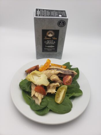 Image of Ramon Pena Smoked Mackerel Silver line plated on a bed of spinach with tomatoes and artichoke