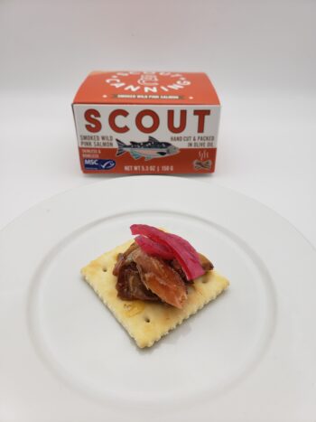 Image of Scout smoked wild pink salmon plated on a saltine with pickled onion