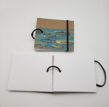 Image of handmade fish book with elastic closure open
