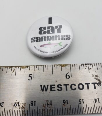 Image of pinback button i eat sardines with ruler for scale