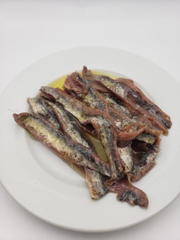 Image of Ortiz anchovies in extra virgin olive oil jar on plate