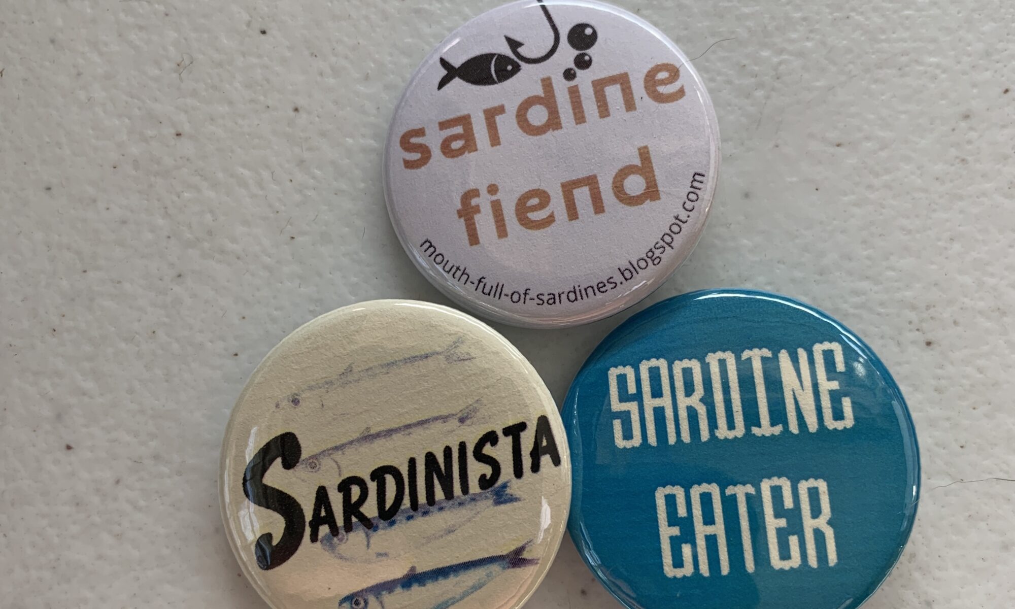 Image of the three pack of Mouth Full of Sardines Themed buttons