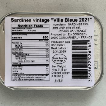 Image of the back of a tin of Les Mouettes d'Arvor Sardines in Extra Virgin Olive Oil, Vintage "Ville Bleue 2021"