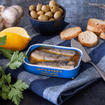 Image of an open tin of Ferrigno Les Belles de Marseille Sardines au Pescadou (Stewed in Lemon, Garlic, Parsley)