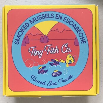 Image of the front of a package of Tiny Fish Co. Smoked Mussels en Escabeche