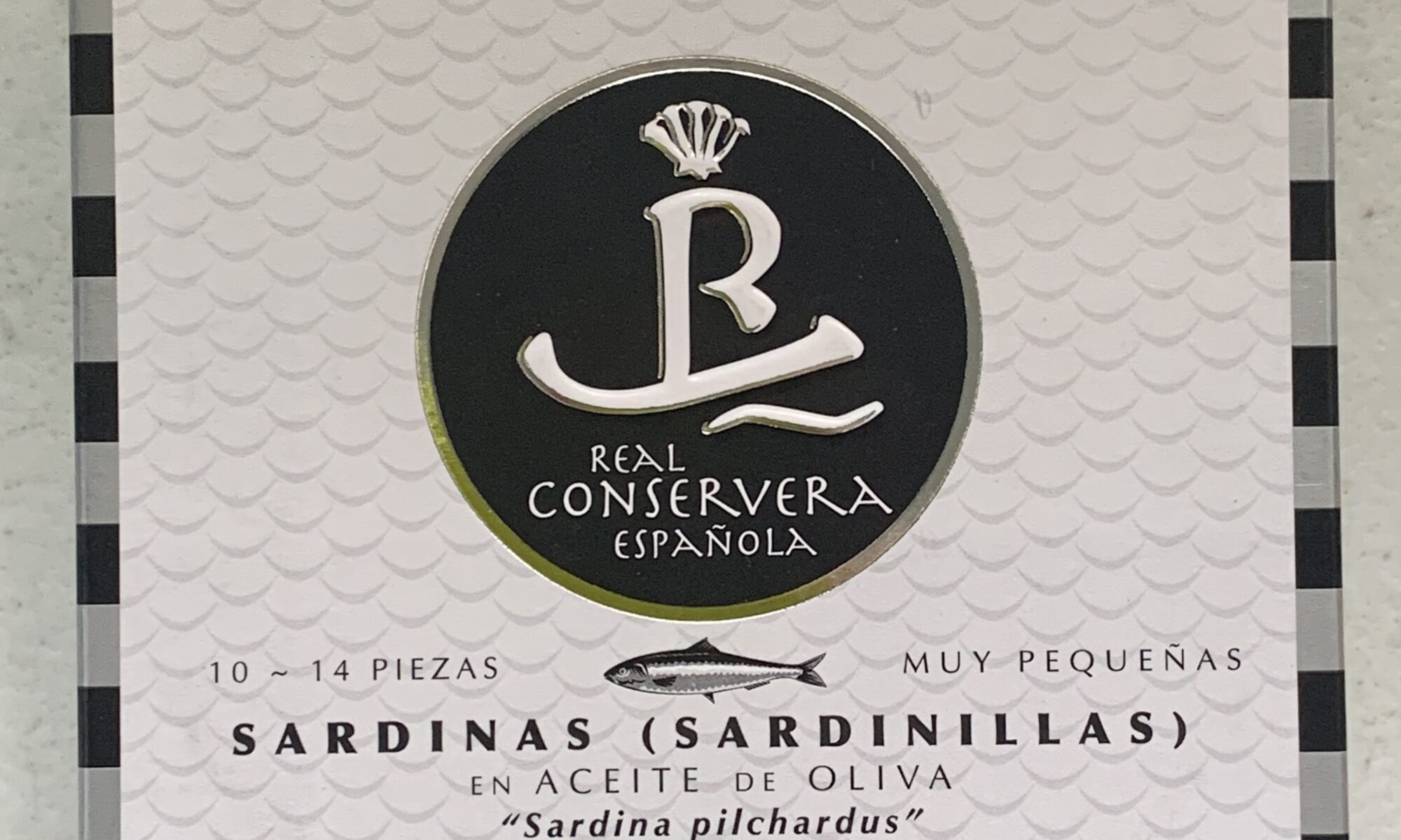 Image of the front of a package of Real Conservera Small Sardines (Sardinillas) in Olive Oil 10/14