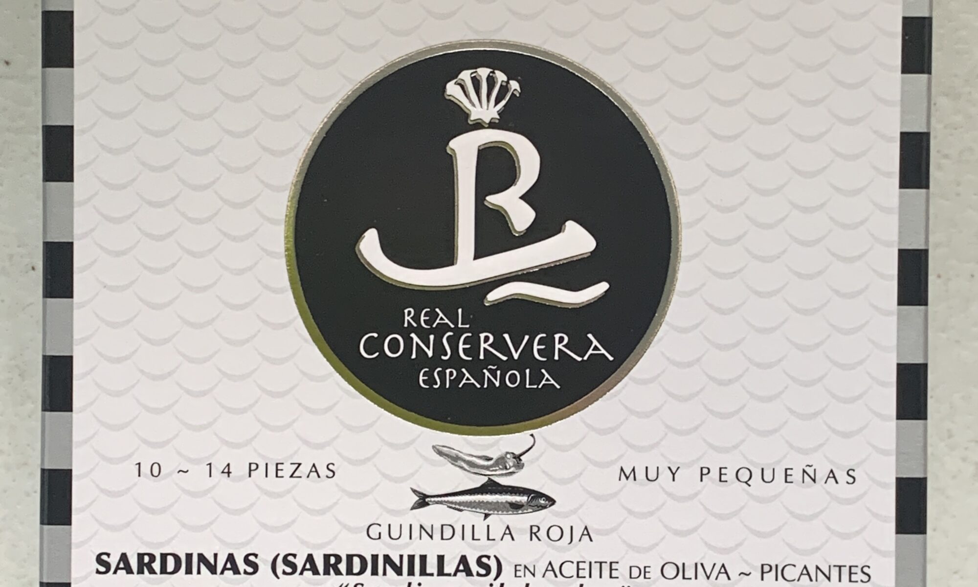 Image of the front of a package of Real Conservera Small Sardines (Sardinillas) in Spicy Olive Oil 10/14
