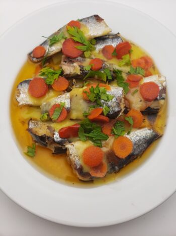 Image of Pinhais spiced sardines on plate with pickled carrots, preserved lemon vinaigrette, and parsley