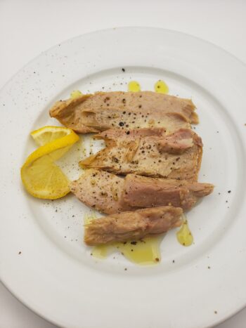 Image of Yurrita Yellowfin ventresca on plate with lemon and cracked pepper