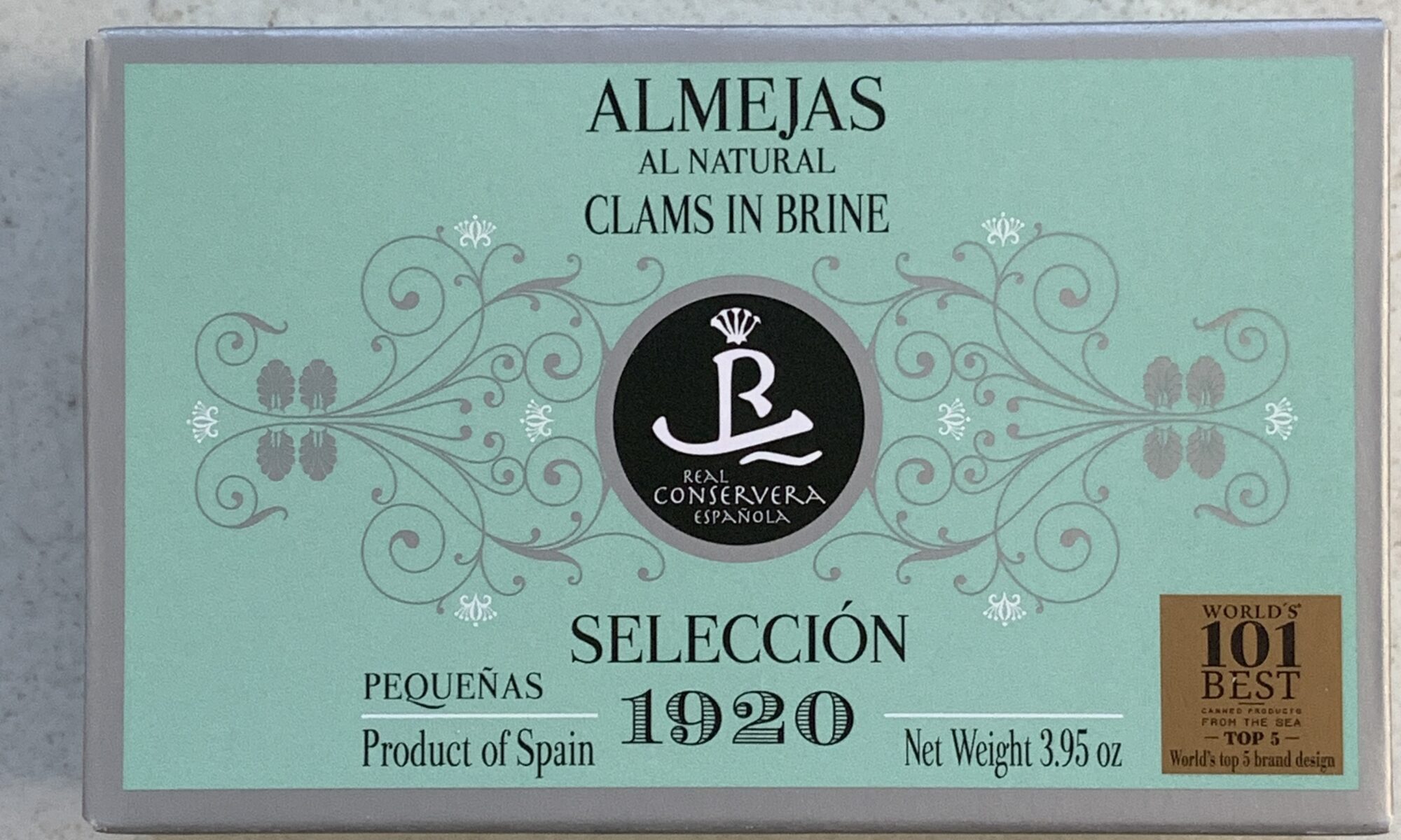 Image of the front of a package of Real Conservera Selección 1920 Clams in Brine